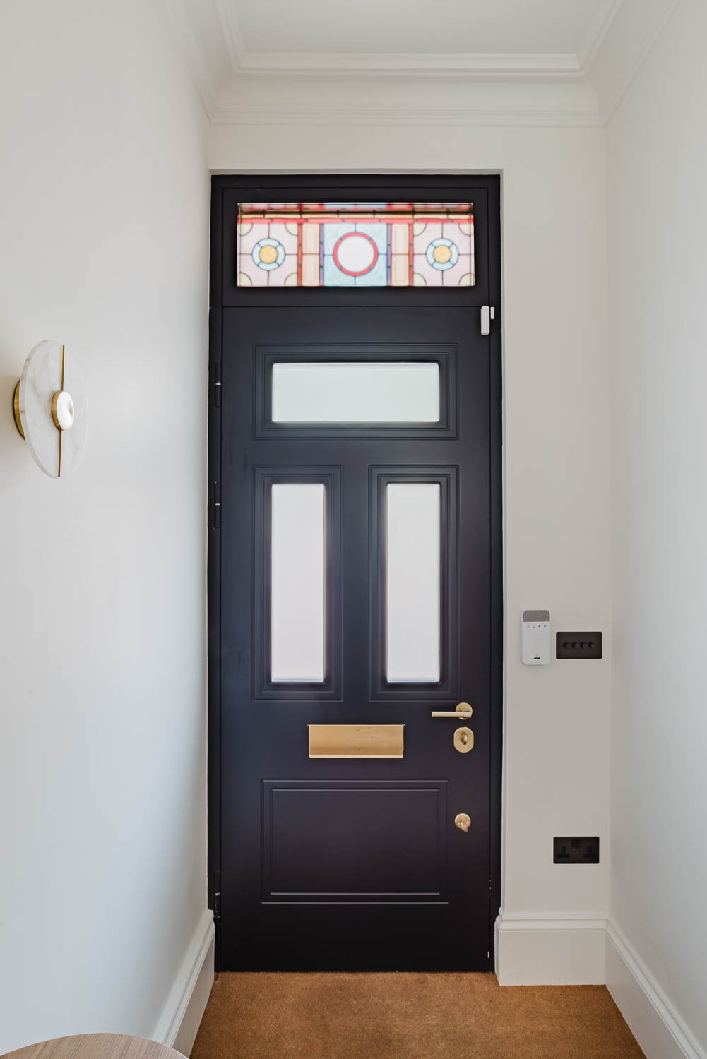 Black traditional steel door with stained glass