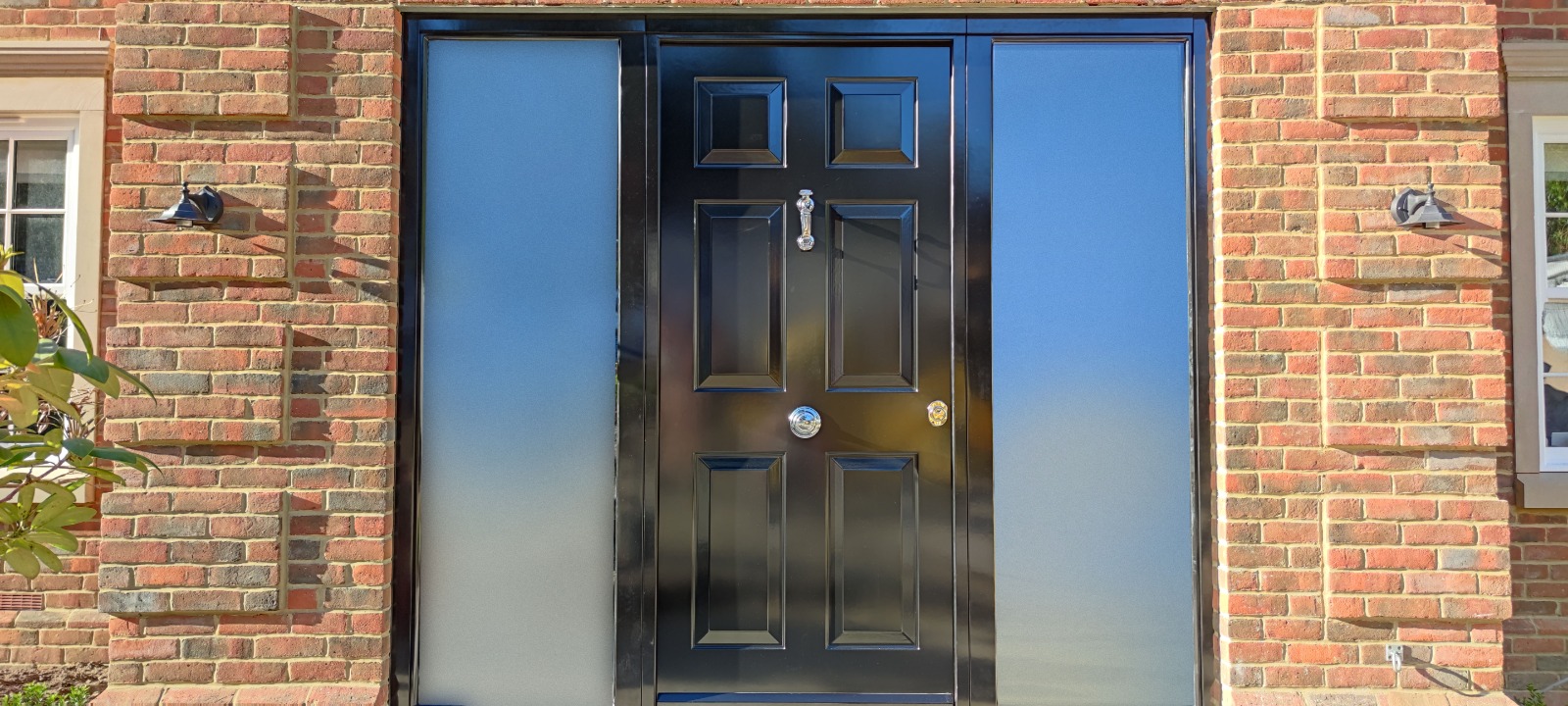 Black traditional steel door with wide frosted sidelights