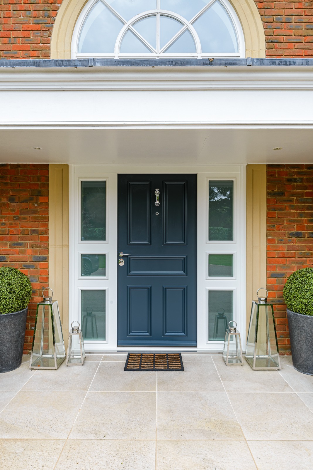 Navy panelled steel door with lanterns and fanlight