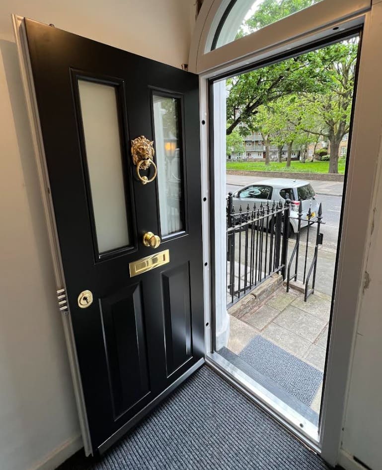 Black traditional steel door with lion knocker open view