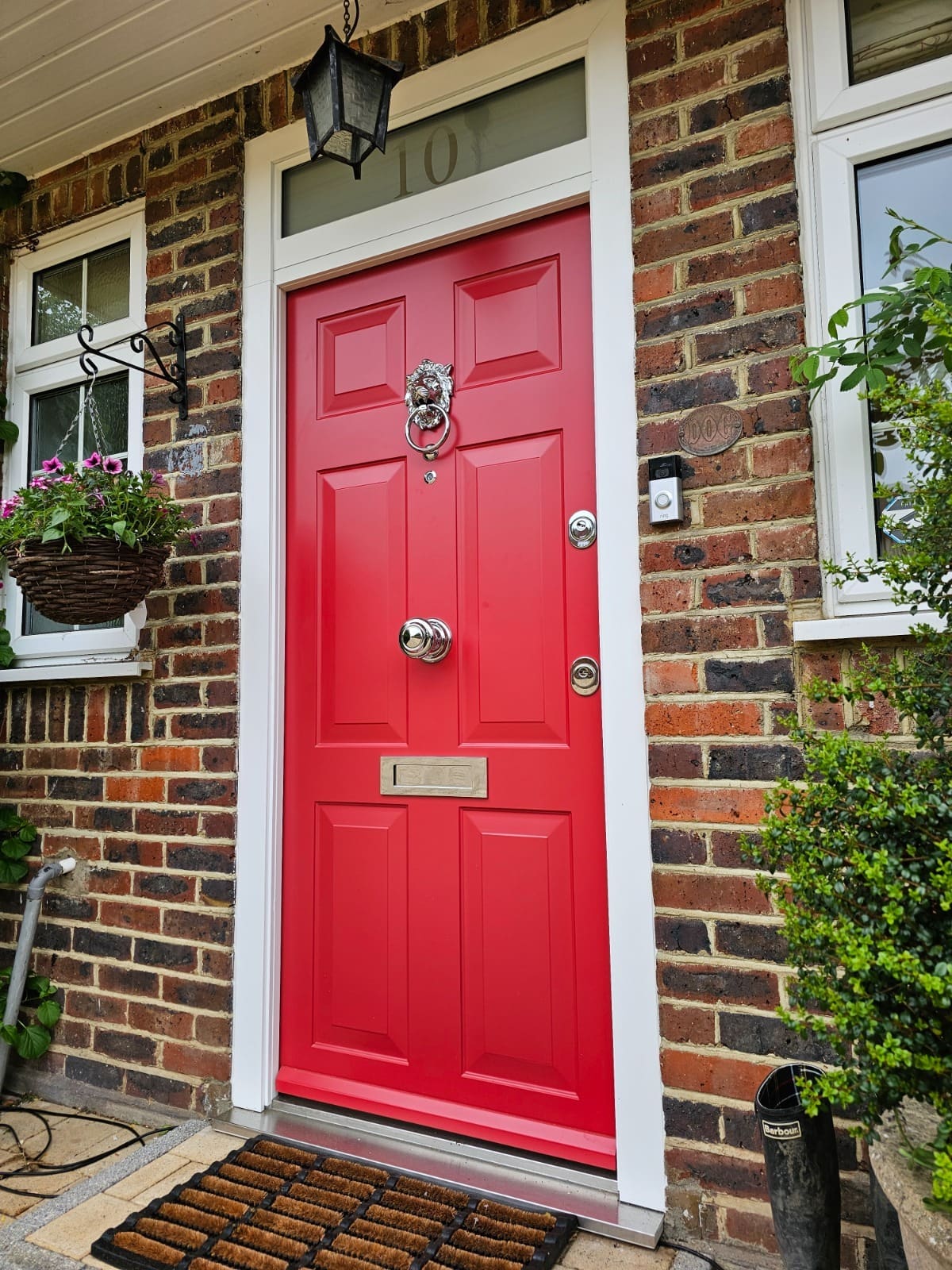 Red traditional steel door with lion knocker — bold colour choice